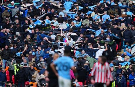 Manchester City fans celebrate the third goal, a hat-trick from Riyad Mahrez, with the Poznan.