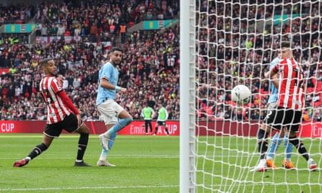 Riyad Mahrez of Manchester City scores their third goal, achieving a hat-trick during the FA Cup Semi-Final between Manchester City and Sheffield United at Wembley Stadium.