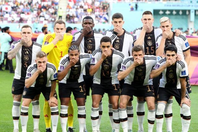 Germany players pose with their hands covering their mouths as they line up for the team photos prior to the FIFA World Cup Qatar 2022 Group E match between Germany and Japan at Khalifa International Stadium