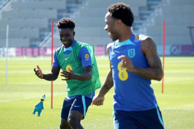 England’s Bukayo Saka and Raheem Sterling throw a rubber toy during a training session at Al Wakrah Stadium 