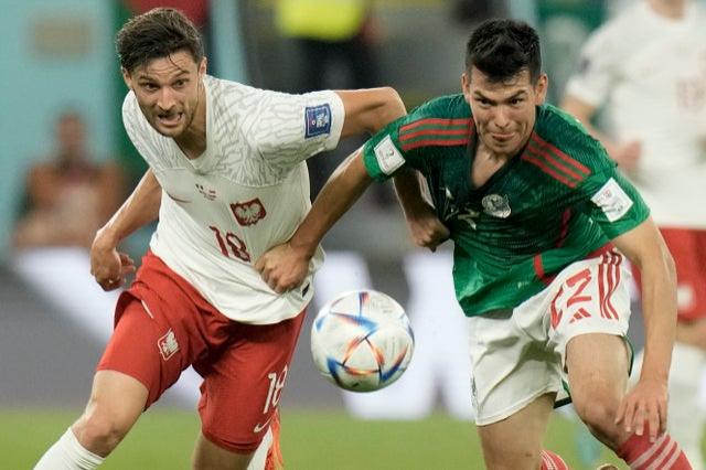 Poland’s Bartosz Bereszynski and Mexico’s Hirving Lozano battle for the ball during the World Cup group C  match at the Stadium 974 in Doha, Qatar